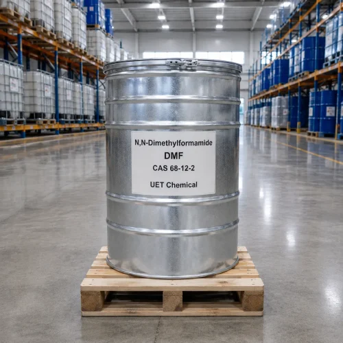 n-n-dimethylformamide-dmf-cas-68-12-2-silver-metal-drum-packaging Silver metal drum of N,N-Dimethylformamide (DMF) CAS 68-12-2 on a wooden pallet in a warehouse, label showing UET Chemical branding and product details.