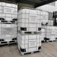 n-n-dimethyloctylamine-dma8-ibc-tote-bulk-storage Stacked white IBC totes (Intermediate Bulk Containers) with metal cages containing N,N-Dimethyloctylamine (DMA8, CAS 7378-99-6), labeled UET Chemical, bulk liquid storage at outdoor chemical warehouse