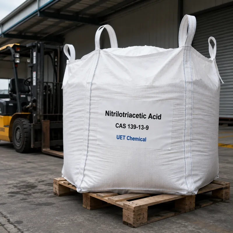 nitrilotriacetic-acid-nta-cas-139-13-9-ton-bag-bulk-supply-uetchmical Large white ton bag of Nitrilotriacetic Acid (NTA) CAS 139-13-9 on a wooden pallet near a forklift, indicating bulk industrial supply and logistics capability by UET Chemical.