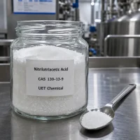nitrilotriacetic-acid-nta-cas-139-13-9-white-crystal-sample-uetchmical Glass jar containing white crystalline Nitrilotriacetic Acid (NTA) CAS 139-13-9 with a metal spoon, displaying high purity for laboratory testing and chelating agent applications by UET Chemical.