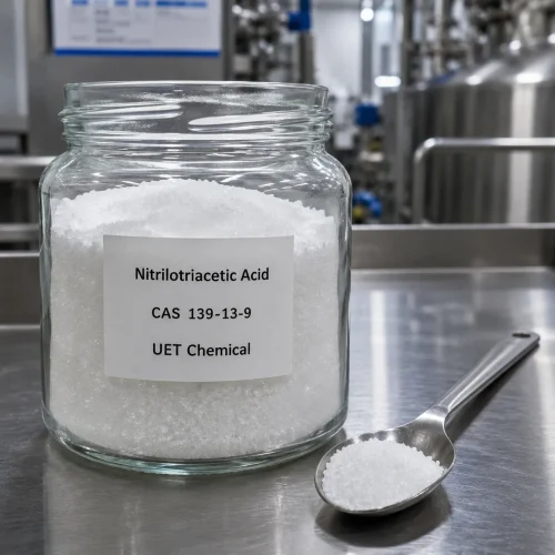 nitrilotriacetic-acid-nta-cas-139-13-9-white-crystal-sample-uetchmical Glass jar containing white crystalline Nitrilotriacetic Acid (NTA) CAS 139-13-9 with a metal spoon, displaying high purity for laboratory testing and chelating agent applications by UET Chemical.