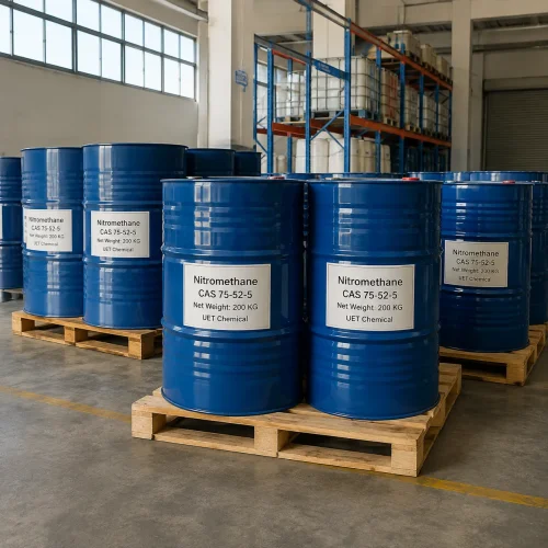 nitromethane-200kg-blue-drum-warehouse-pallet Multiple 200kg blue plastic drums of Nitromethane (CAS 75-52-5) on wooden pallets in industrial warehouse, labeled UET Chemical, bulk packaging for solvent and fuel additive applications