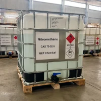 nitromethane-ibc-tote-tank-un1261-toxic-flammable White IBC tote tank with metal cage frame containing Nitromethane (CAS 75-52-5), labeled UET Chemical, displaying UN 1261, Flammable Liquid Class 3, and Toxic hazard symbols, suitable for large-volume industrial transport