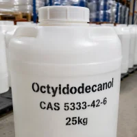 octyldodecanol-cas-5333-42-6-25kg-plastic-jerrycan-packaging White plastic jerrycan of Octyldodecanol CAS 5333-42-6 with black stenciled text showing product name, CAS number, and 25kg net weight, stored in warehouse with stacked containers in background.