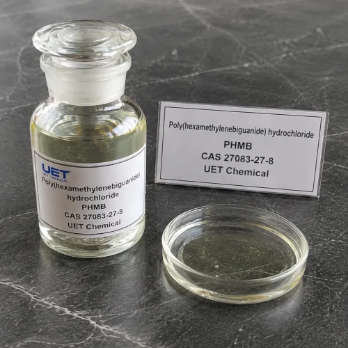 phmb-poly-hexamethylene-biguanide-hydrochloride-sample-bottle Clear glass reagent bottle filled with pale yellow liquid Poly(hexamethylenebiguanide) hydrochloride (PHMB, CAS 27083-27-8) on dark stone surface with glass petri dish beside, labeled UET Chemical, sample for disinfectant and antimicrobial agent verification