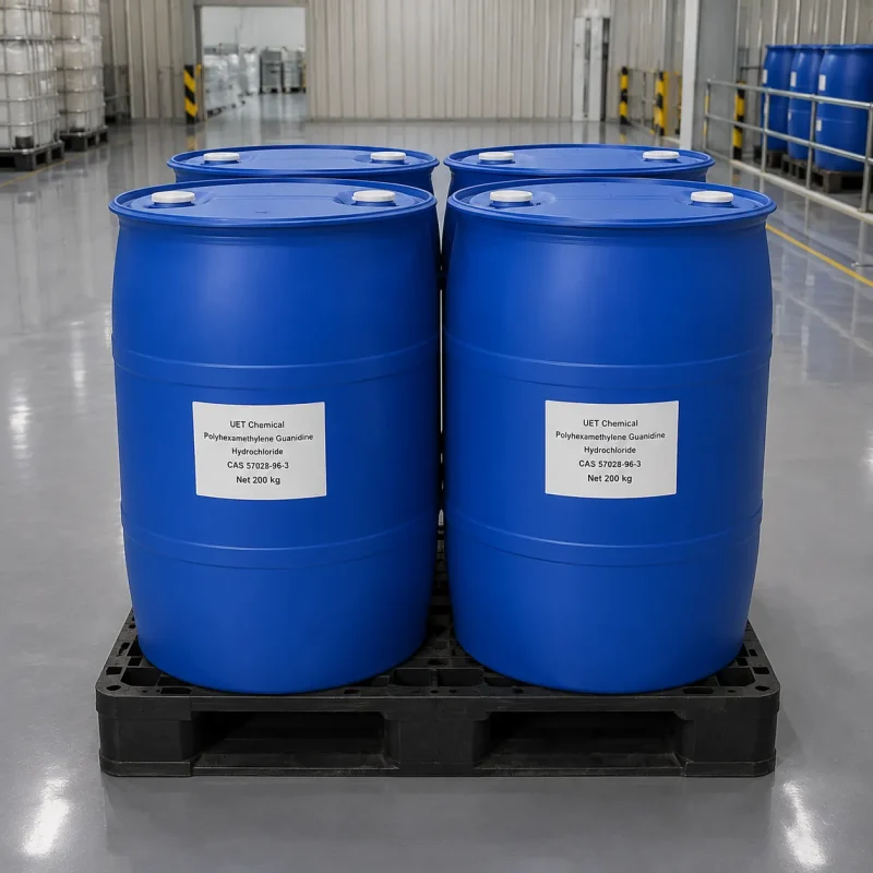 phmg-hcl-blue-drum-200kg-pallet-warehouse Four blue plastic drums of Polyhexamethylene Guanidine Hydrochloride (PHMG HCl, CAS 57028-96-3) on black pallet in warehouse, each labeled UET Chemical with Net 200 kg, bulk packaging for industrial disinfectant and water treatment applications