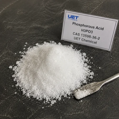 Pile of white crystalline powder Phosphorous Acid (H3PO3, CAS 13598-36-2) on dark stone surface with metal spatula, labeled UET Chemical, sample for agricultural fungicide or water treatment chemical verification