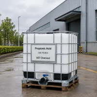 propionic-acid-cas-79-09-4-ibc-tote-outdoor-factory-uetchmical IBC tote container of Propionic Acid CAS 79-09-4 placed outdoors near factory building, designed for large-volume transport and industrial application by UET Chemical.