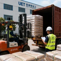 snf-superplasticizer-container-loading-forklift-uet-export Industrial export logistics: A forklift loading palletized UET brand SNF Superplasticizer CAS 9084-06-4 bags into a container at the factory, while a logistics staff inspects the packing list, ensuring reliable B2B bulk delivery.
