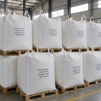 sodium-molybdate-cas-7631-95-0-1000kg-ton-bag-bulk Large white ton bags (Net Weight: 1000kg each) of Sodium Molybdate (CAS 7631-95-0) stacked on wooden pallets in warehouse, labeled UET Chemical, industrial bulk packaging for large-scale fertilizer or chemical manufacturing