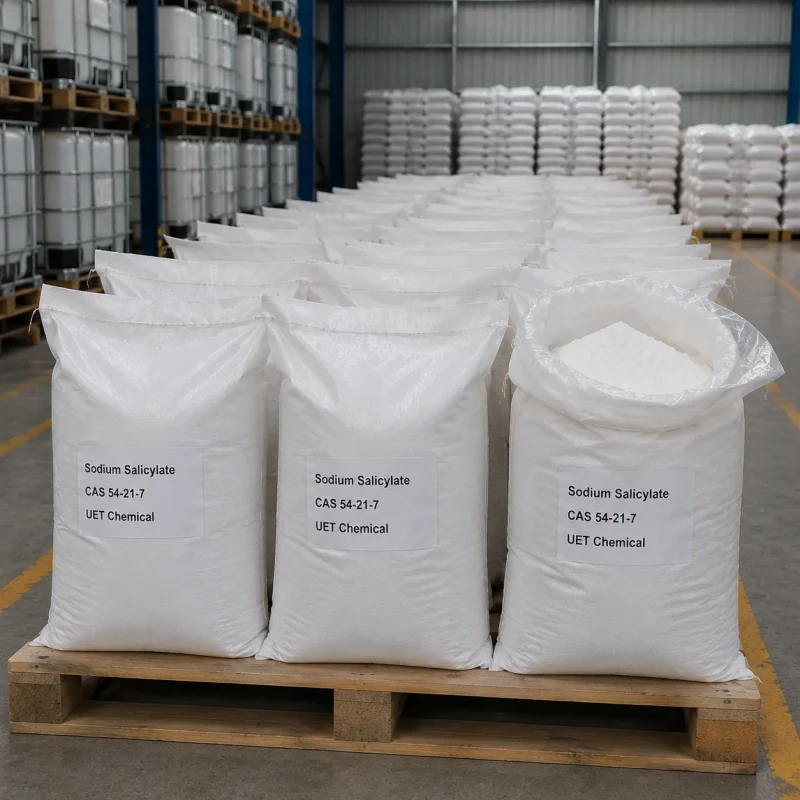 sodium-salicylate-bulk-white-woven-bag-warehouse-stock Rows of large white woven bags filled with white powder Sodium Salicylate (CAS 54-21-7) on wooden pallets in industrial warehouse, one bag open showing the contents, labeled UET Chemical, bulk supply for pharmaceutical and food applications