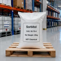 sorbitol-cas-50-70-4-25kg-white-woven-bag-packaging 25kg white woven bag of Sorbitol CAS 50-70-4 on a wooden pallet in a warehouse, label showing net weight and UET Chemical branding, with stacked bags visible on shelves in the background.