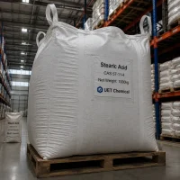 stearic-acid-cas-57-11-4-1000kg-ton-bag-warehouse A 1000kg white ton bag of Stearic Acid CAS 57-11-4 on wooden pallet, labeled UET Chemical, in a warehouse with high shelving units.