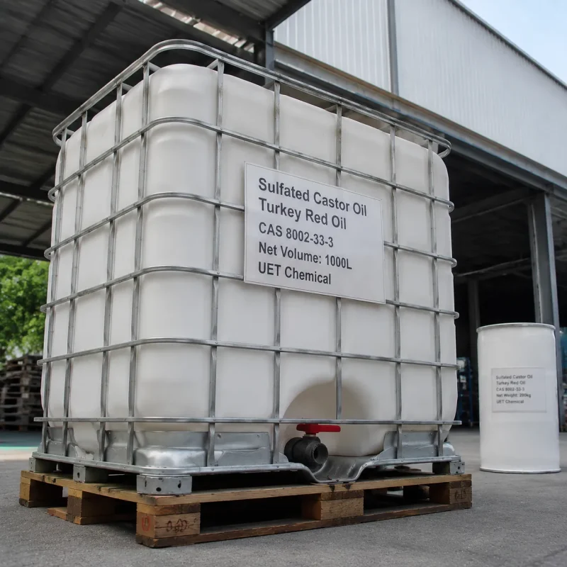 sulfated-castor-oil-turkey-red-oil-cas-8002-33-3-1000l-ibc-tank A 1000L white IBC tank of Sulfated Castor Oil (Turkey Red Oil) CAS 8002-33-3 on wooden pallet, with a 200kg drum beside it for scale, outside a factory building.