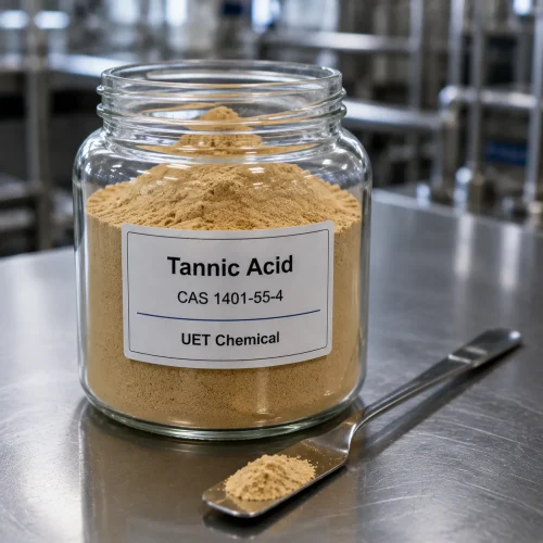 tannic-acid-cas-1401-55-4-powder-sample-glass-jar-uetchmical Glass jar containing light brown Tannic Acid powder CAS 1401-55-4 with a spatula, displaying high purity and fine texture for quality inspection by UET Chemical.