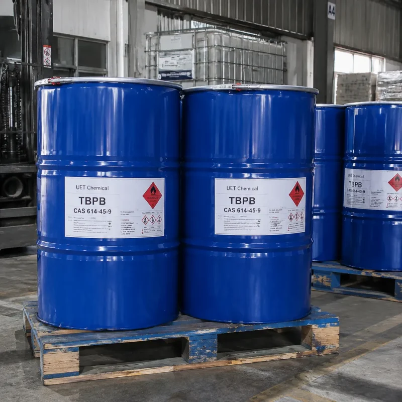 tbpb-cas-614-45-9-blue-steel-drums-bulk-packaging Blue steel drums containing TBPB CAS 614-45-9 with hazard warning labels stacked on a wooden pallet.