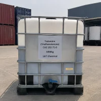 A 1000kg IBC tote of Trolamine (Triethanolamine) CAS 102-71-6 with metal frame and blue valve, placed on concrete ground with shipping containers visible in background.