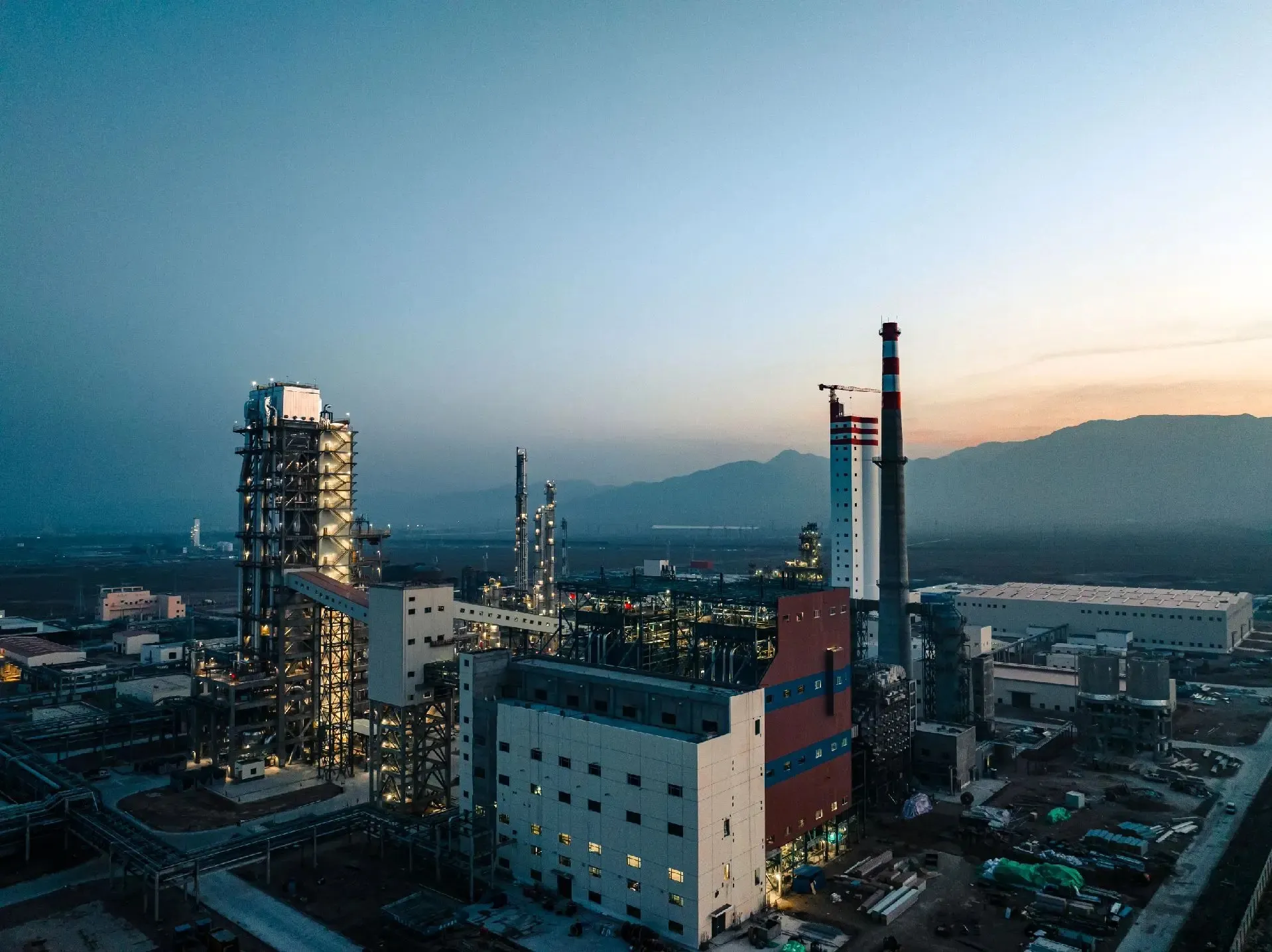 An aerial view of UETChem's primary chemical production facility at sunset. This industrial campus represents our core manufacturing strength and commitment to high-quality raw material distribution worldwide.