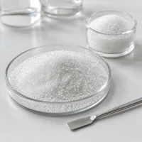 white-crystalline-citric-acid-anhydrous-granules-cas-77-92-9 White crystalline citric acid anhydrous granules CAS 77-92-9 shown in glass laboratory dishes with stainless spatula